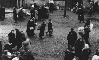 Jews carrying bundles of possessions before their deportation from the Kovno ghetto. Kovno, Lithuania, October 1943